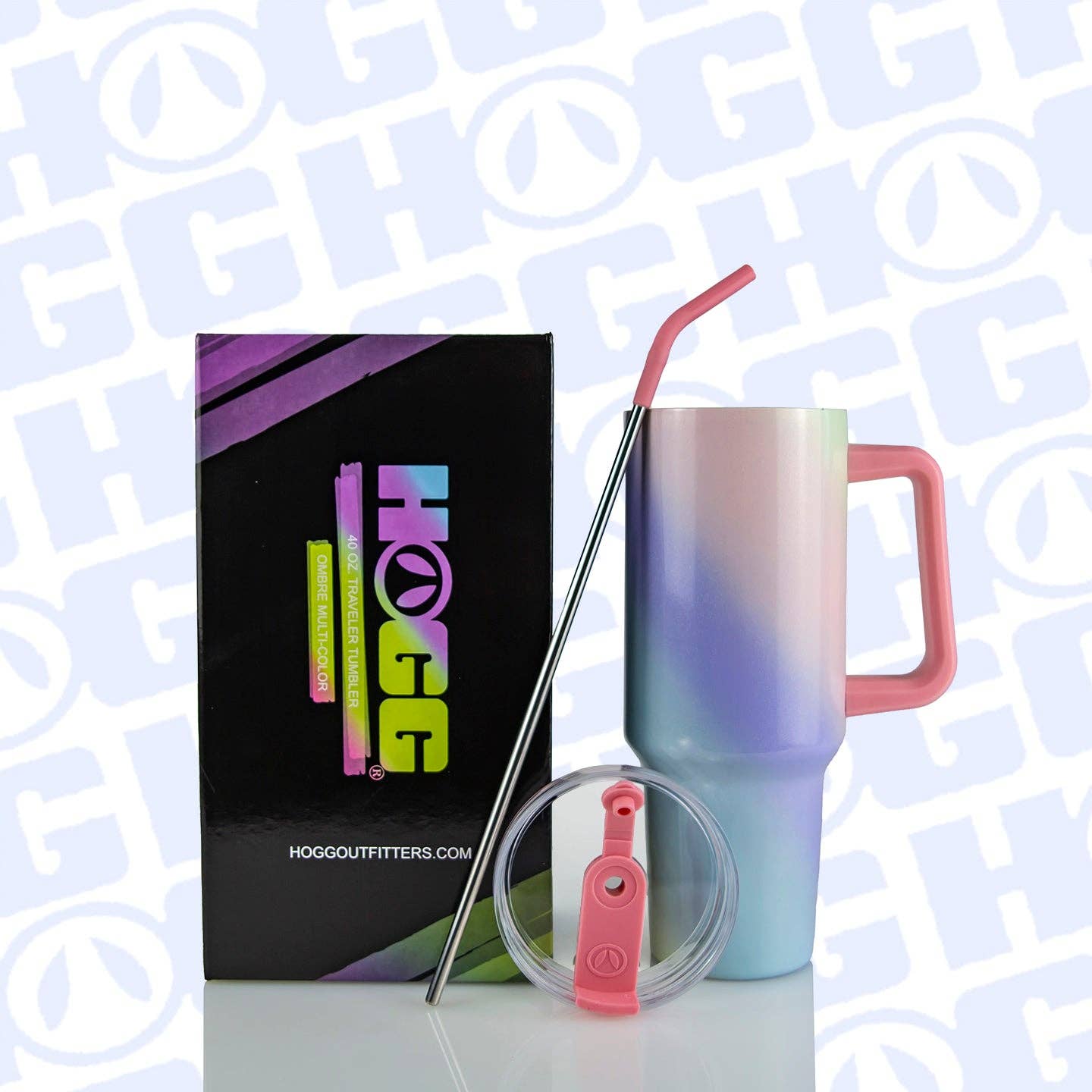 Gradient tumbler with pink handle and straw, HOGG Outfitters box, and clear lid on a light blue background.