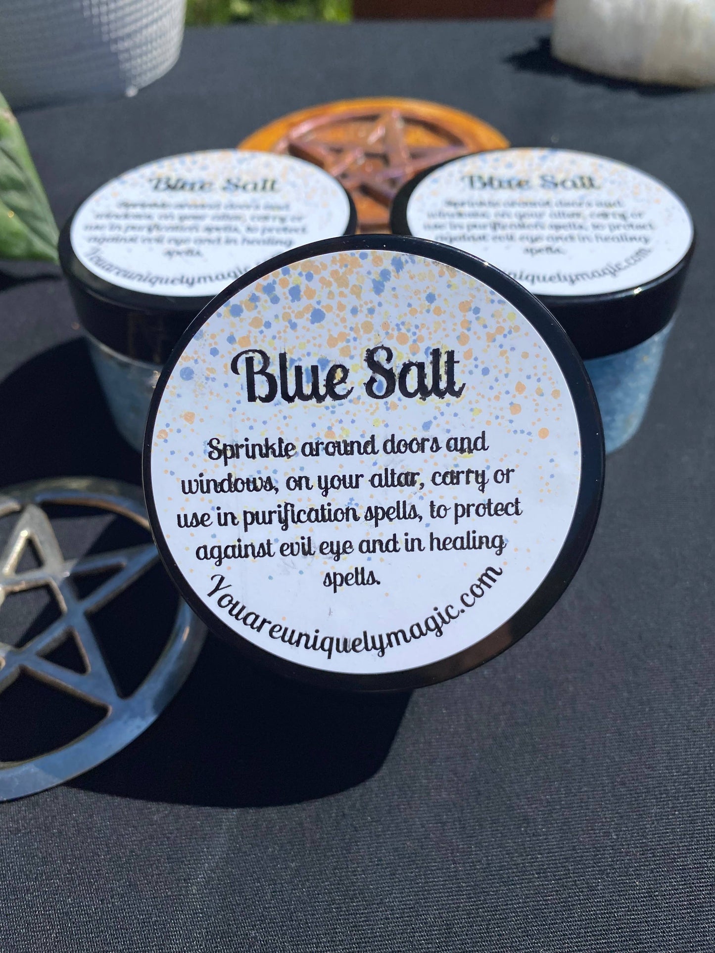 Blue Salt containers with labels on a dark surface