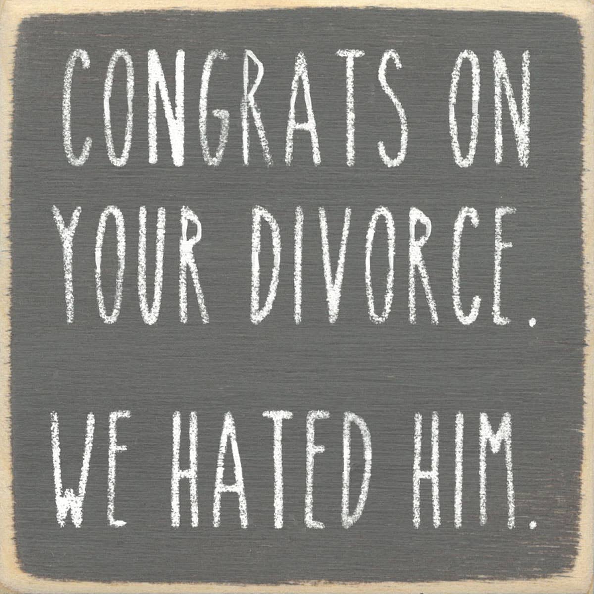 Text sign on a wooden background with a humorous message about divorce.
