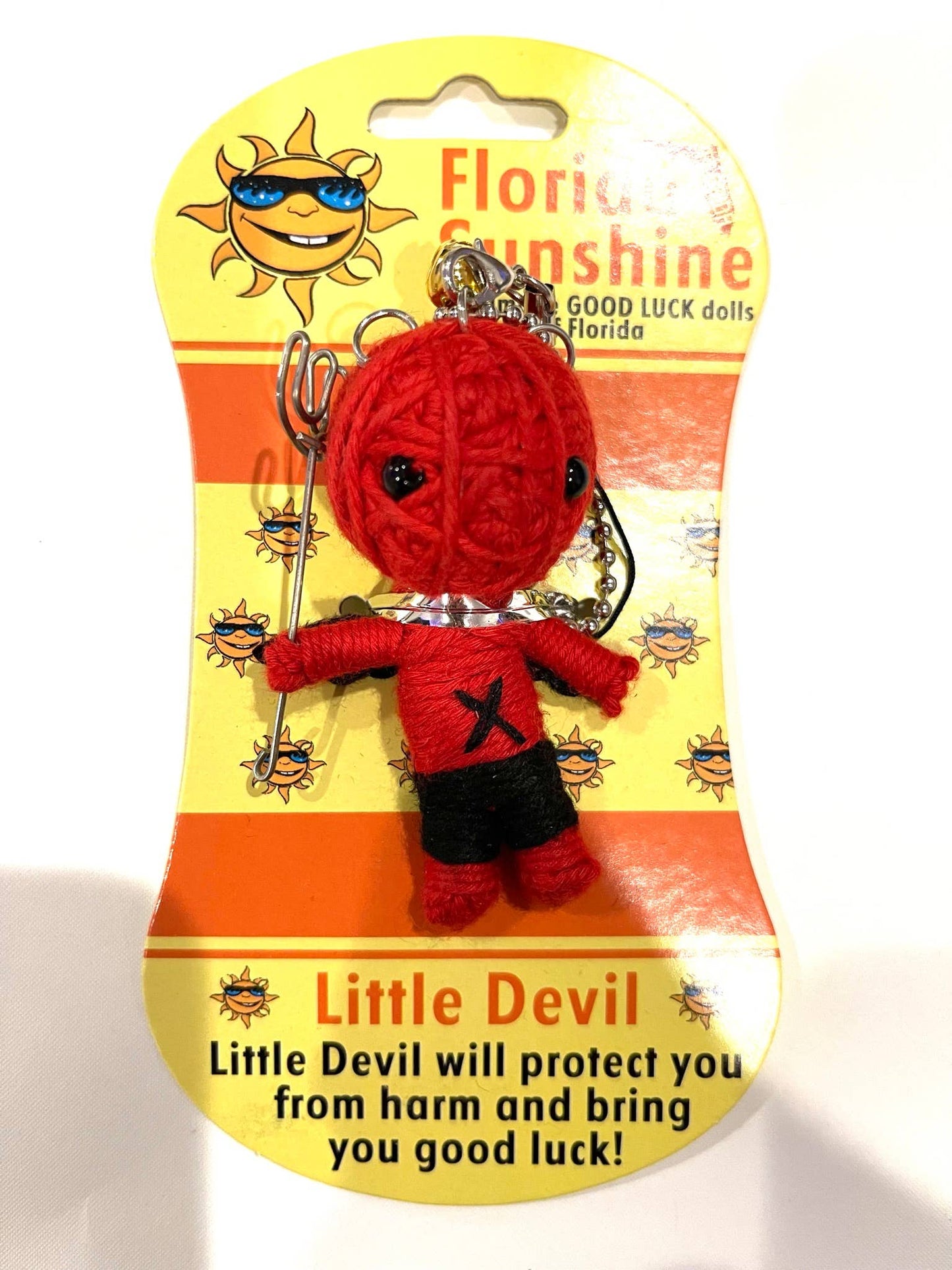 Red 'Little Devil' good luck voodoo charm on a Florida Sunshine packaging