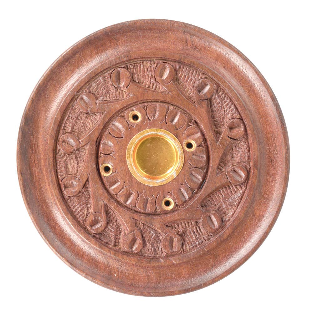 Decorative copper doorbell with embossed design on a white background
