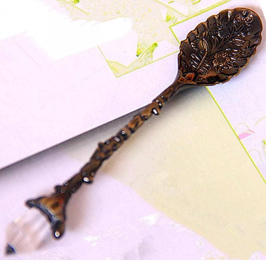 Decorative bronze spoon on a floral background