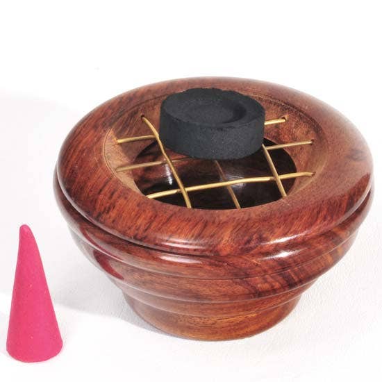 Wooden incense burner with a pink cone on a white background