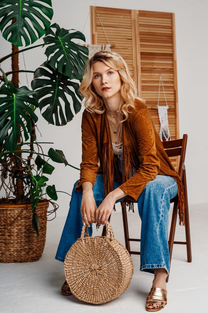 Beautiful woman with a straw boho purse