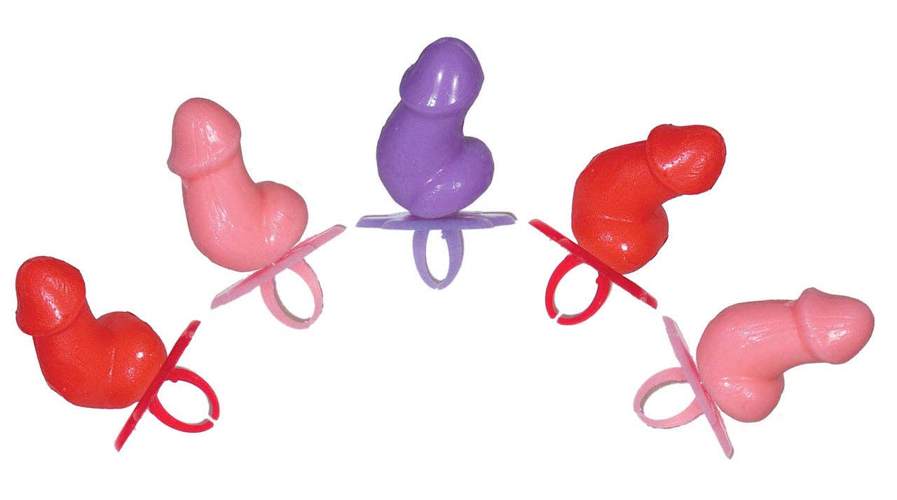 Colorful plastic baby pacifiers on a white background