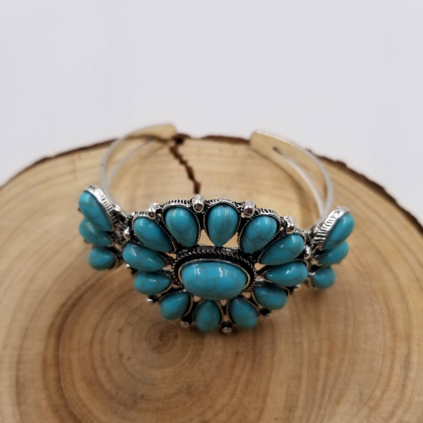 Turquoise bracelet with silver accents on a wooden surface