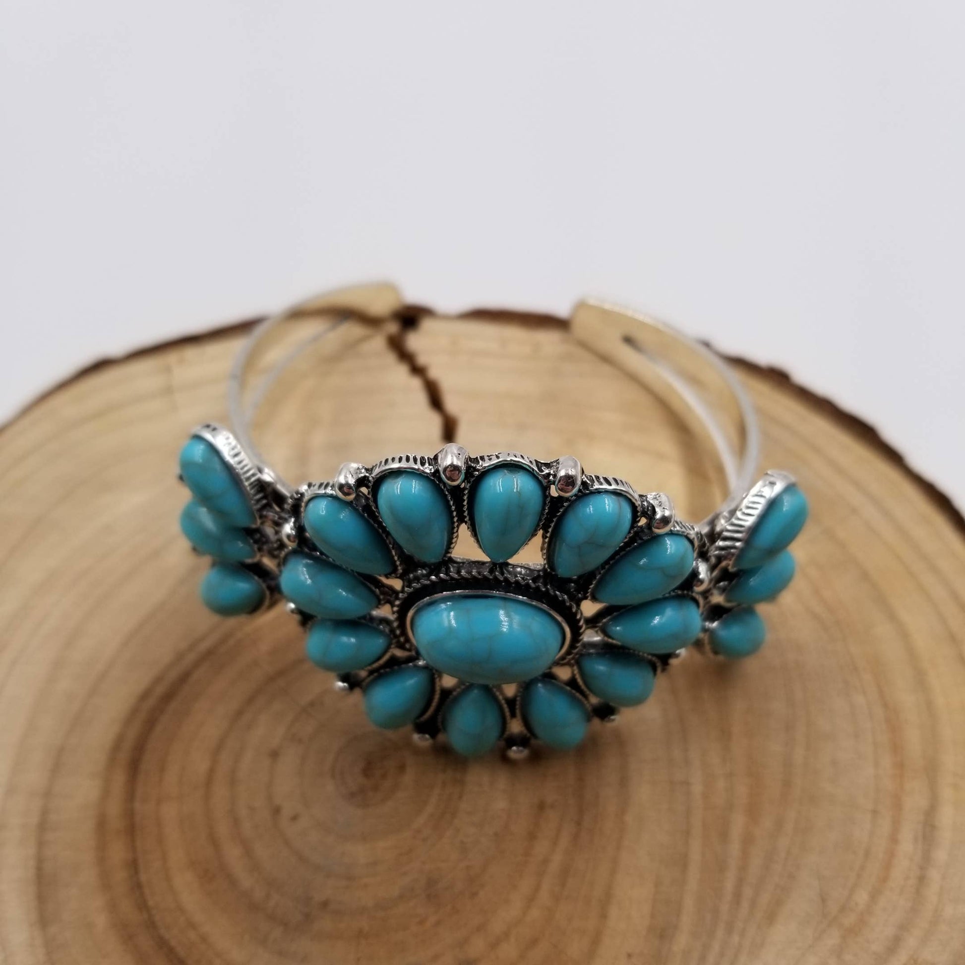 Turquoise bracelet with silver accents on a wooden surface