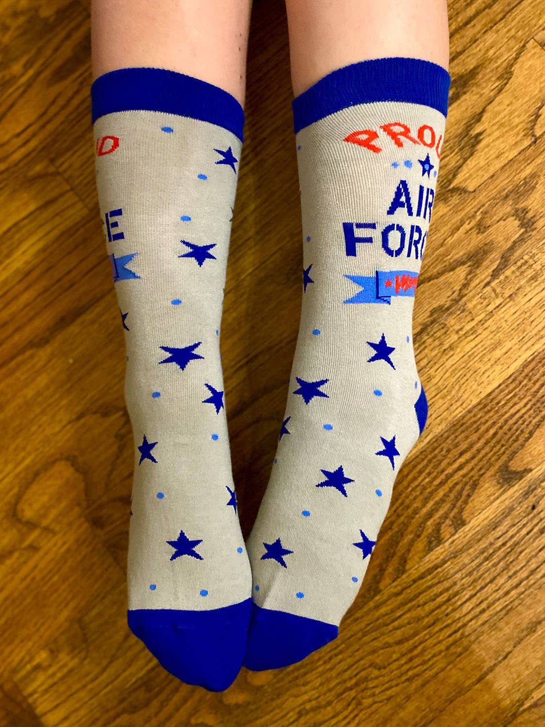 White socks with blue stars and text on a wooden floor