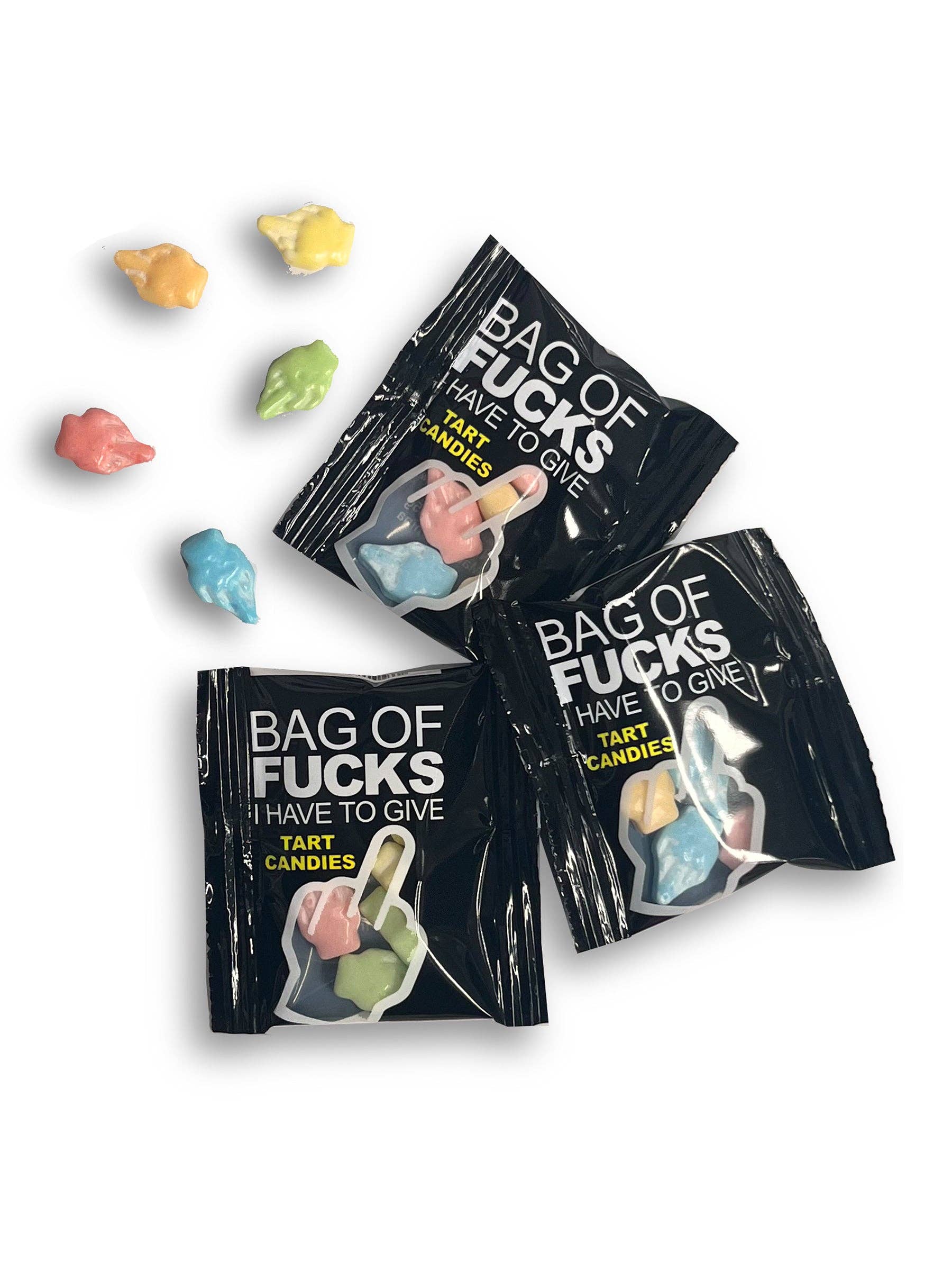 Three black bags labeled 'Bag of Fucks I Have to Give' with colorful candy on a white background