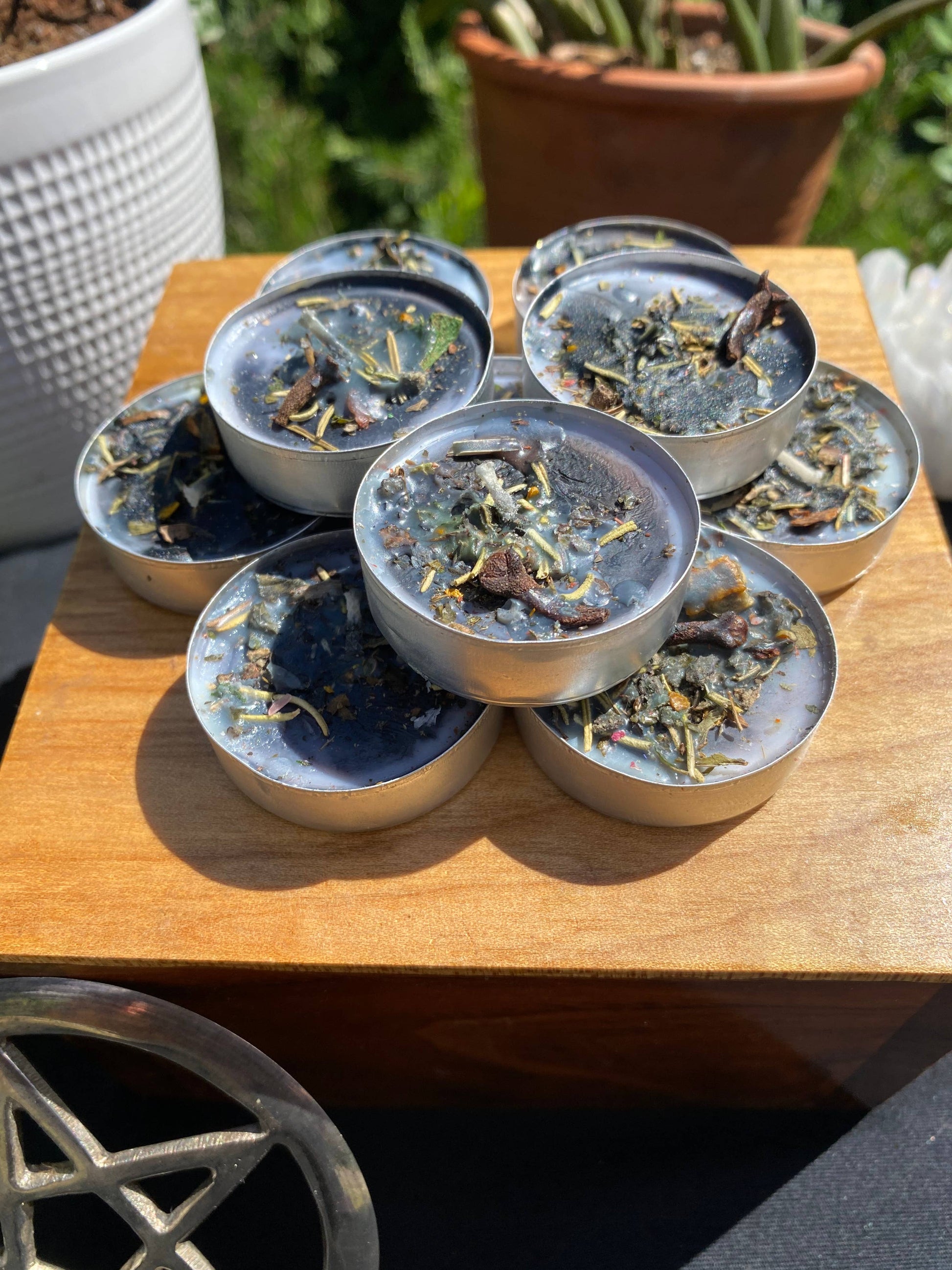 Set of small containers with a natural product on a wooden surface outdoors