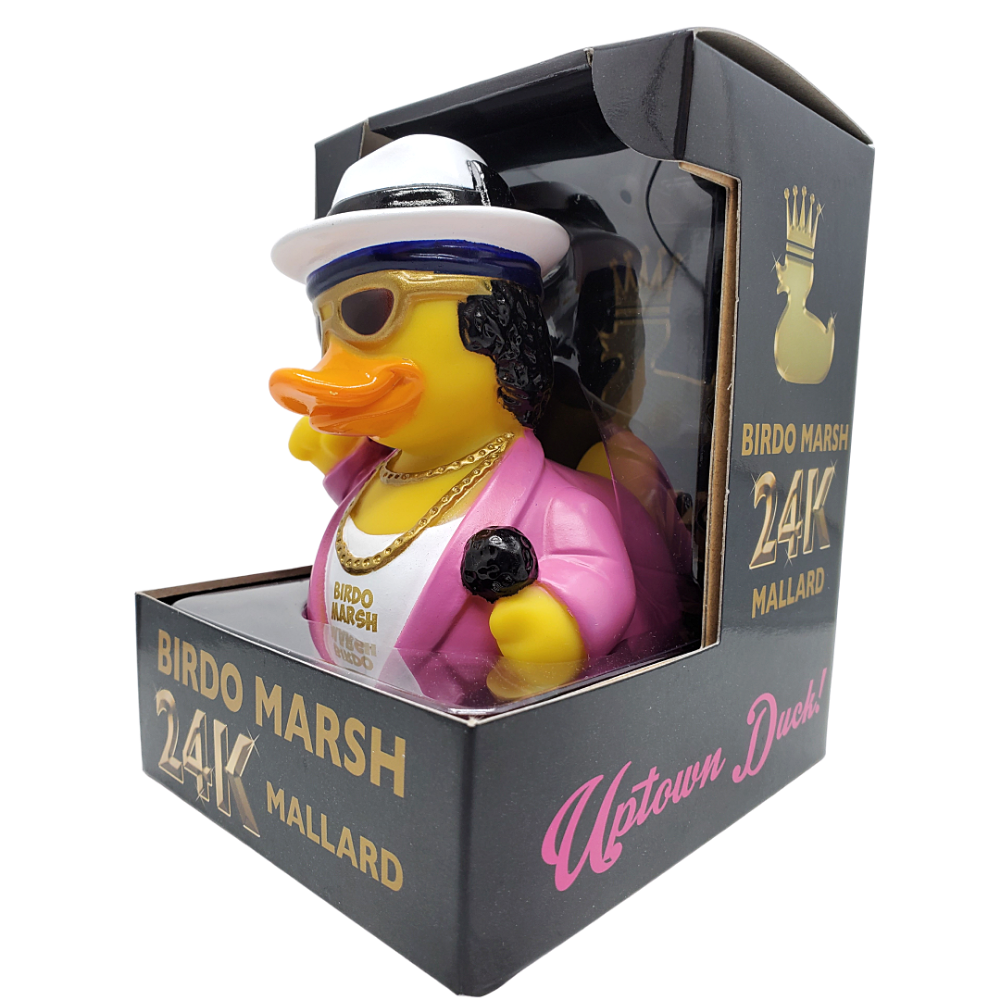 Decorative rubber duck in a box with 'Uptown Duck' branding