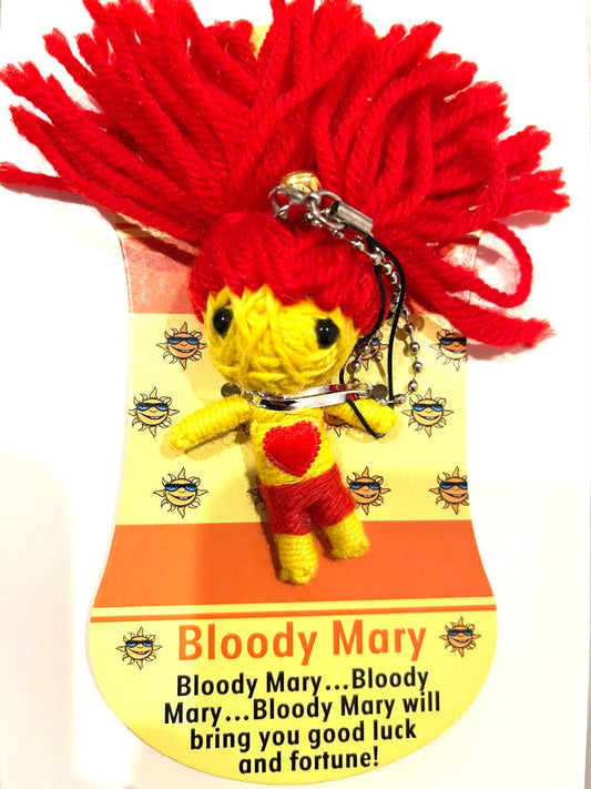 Keychain voodoo doll with red hair and yellow body on a decorative card with text