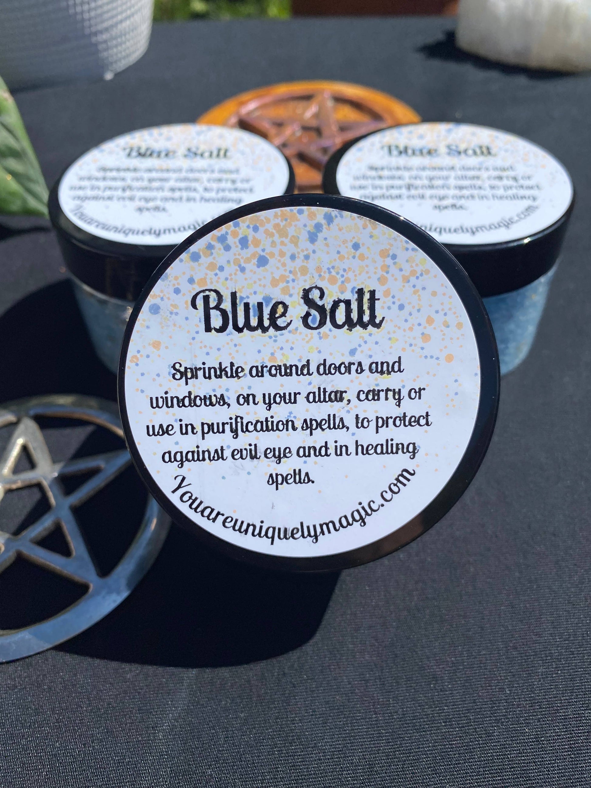 Blue Salt containers with labels on a dark surface