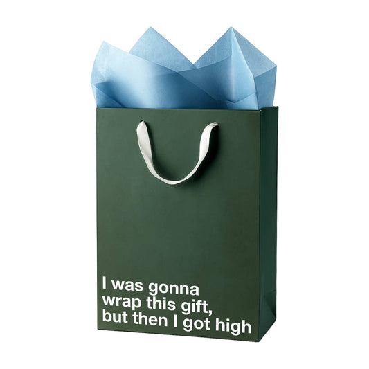 Green gift bag with blue tissue paper and humorous text on a white background