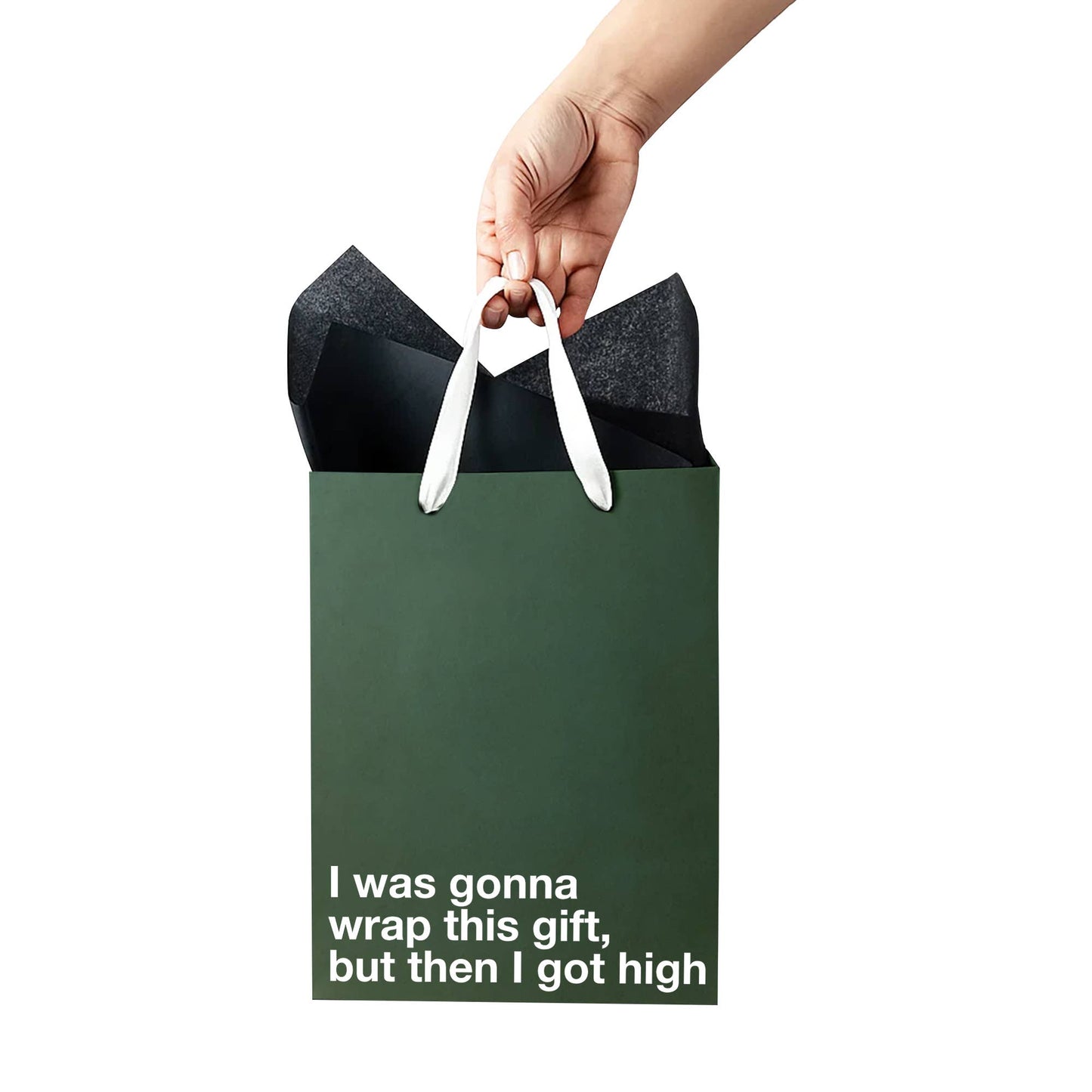Hand holding a green gift bag with text on a white background