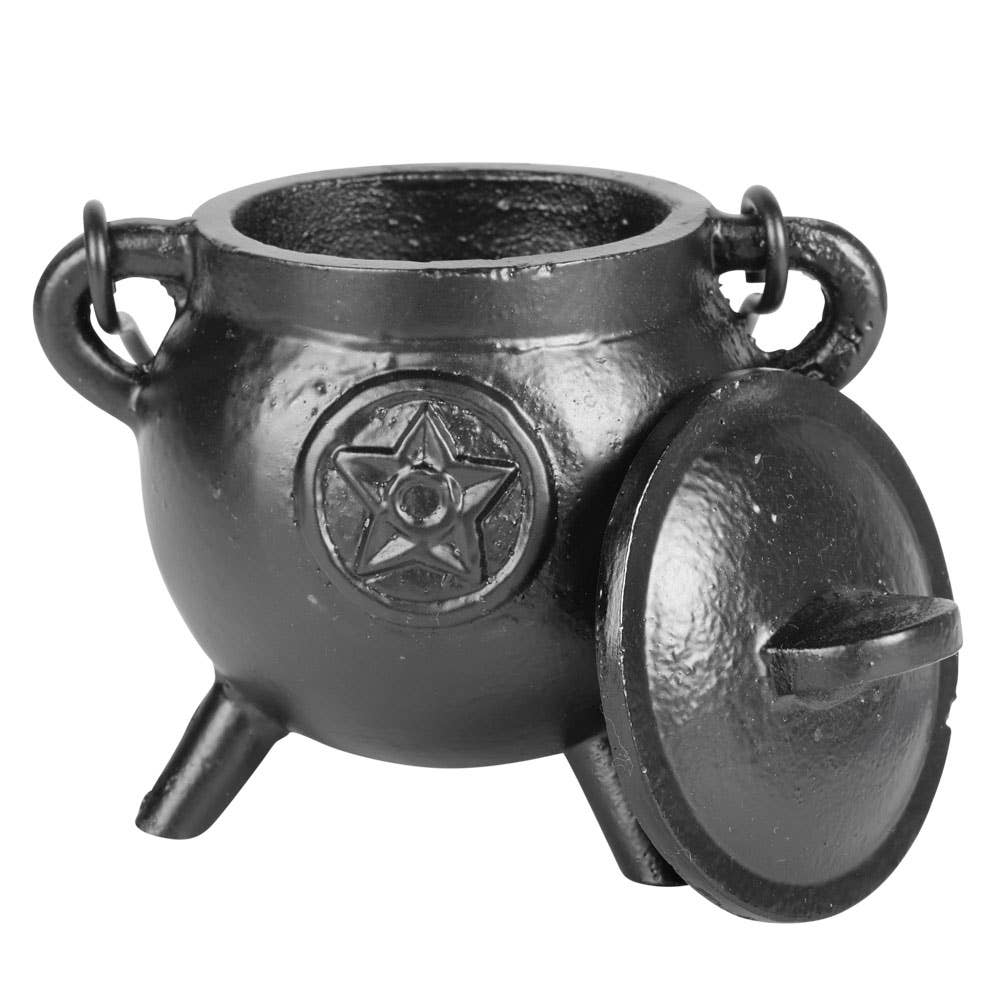 Black cast iron cauldron with a pentagram design on a white background
