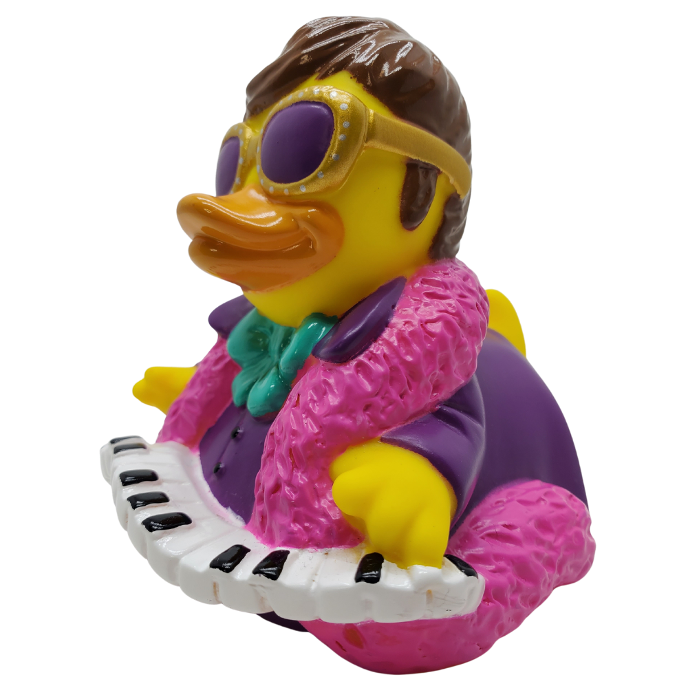 Toy duck with sunglasses and pink jacket playing a keyboard on a white background