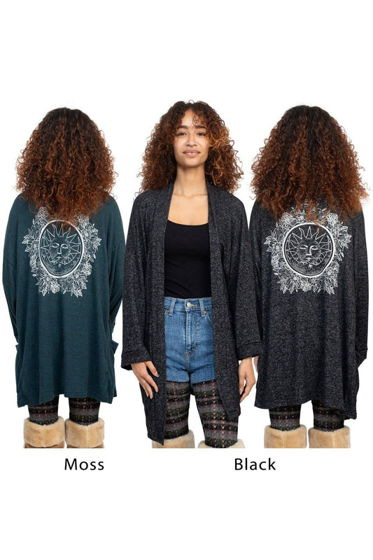 Woman wearing a long cardigan with a mandala design on the back, shown in Moss and Black colors.