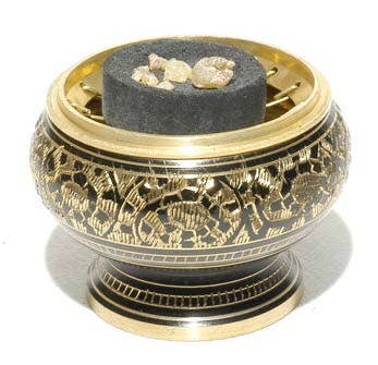 Decorative incense burner with intricate designs on a white background
