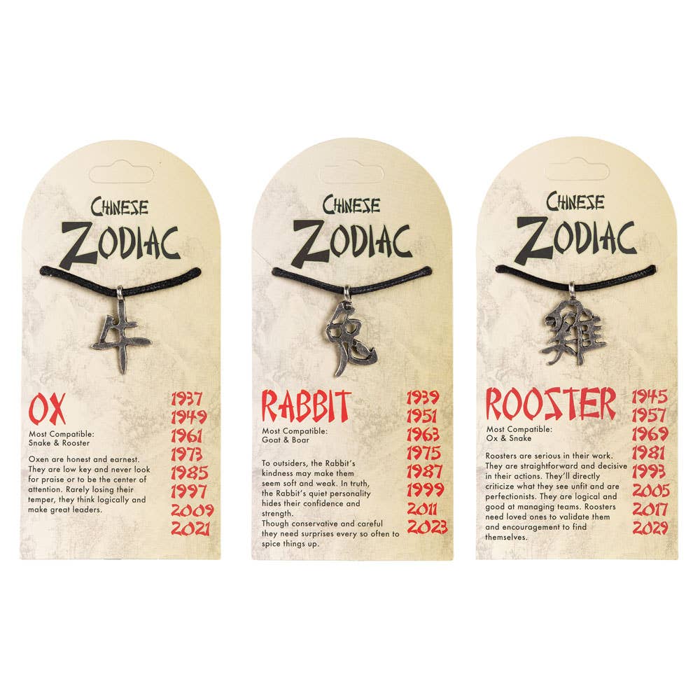 Three Chinese Zodiac necklaces on display with corresponding years on beige cards.
