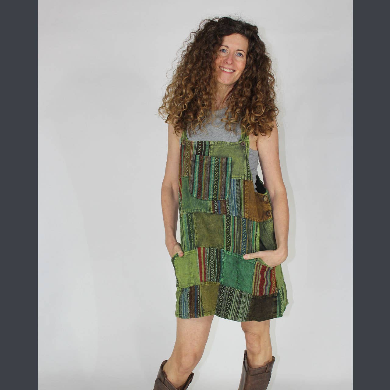 Woman wearing a patchwork dress with a plain background