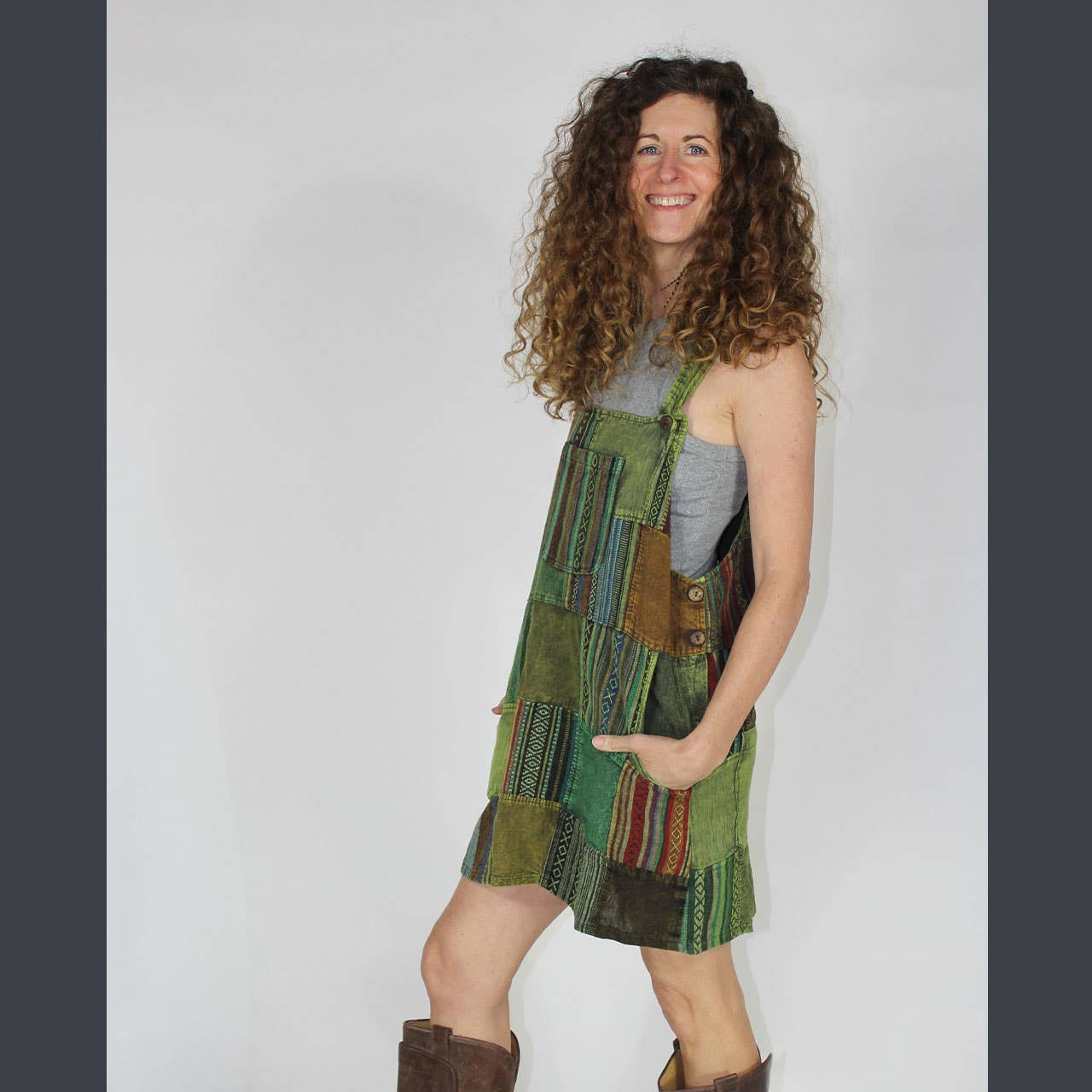 Woman wearing a patchwork dress with a plain background