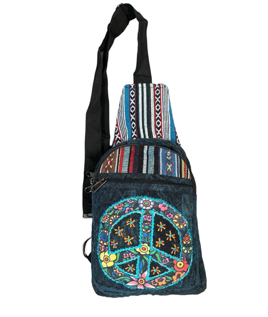 Denim crossbody bag with peace symbol design and colorful patterns on a white background