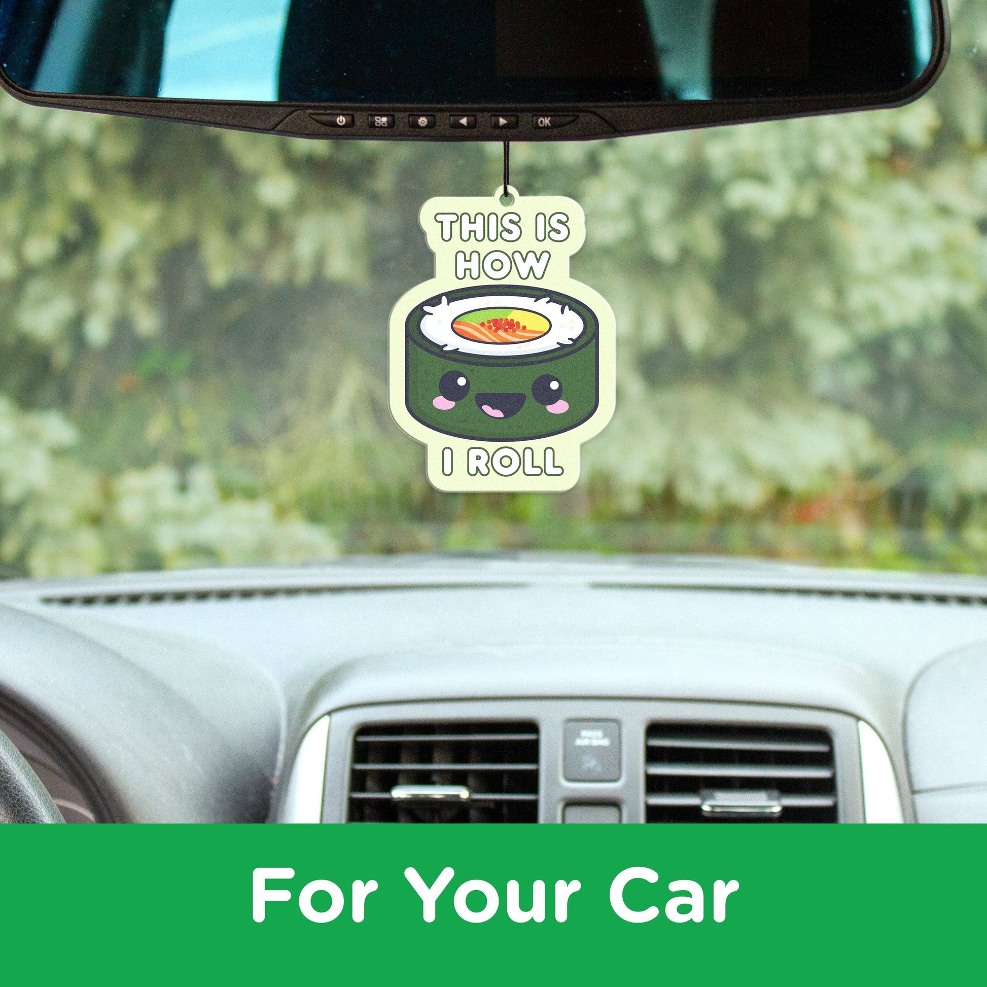 Car air freshener with cartoon sushi design hanging from a car's rearview mirror.