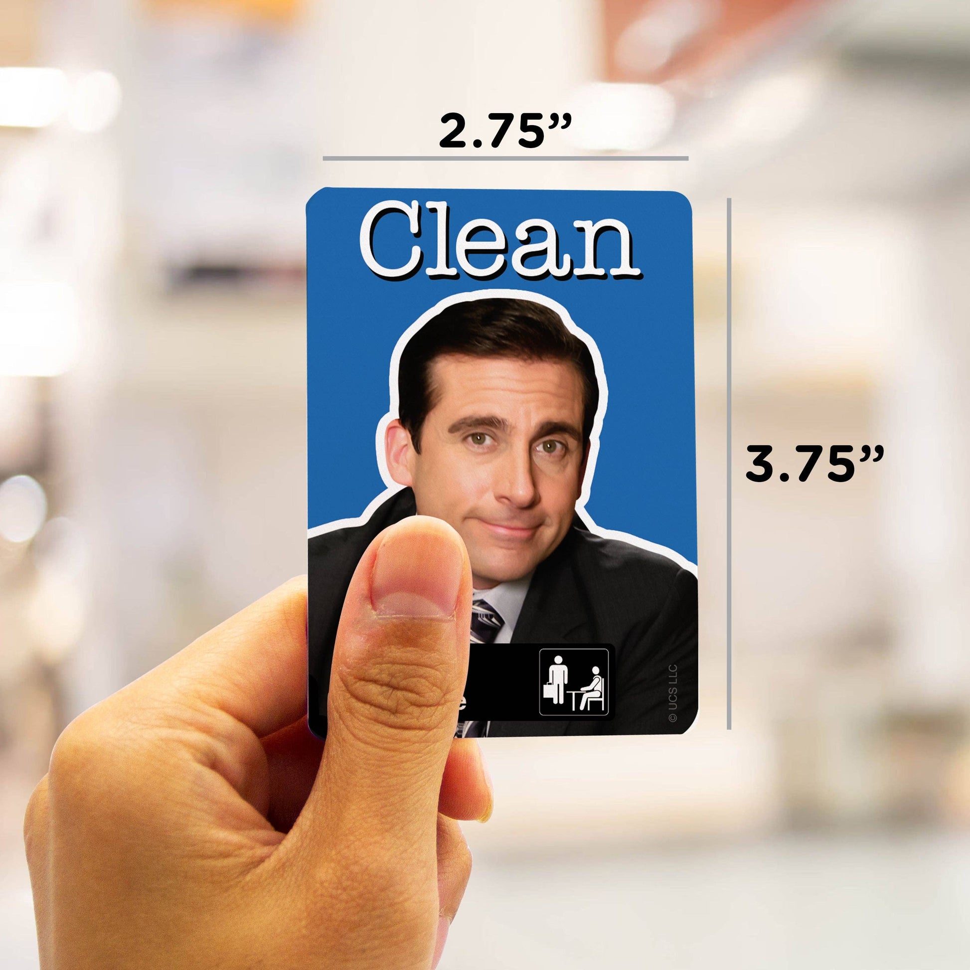 Card with a face on it held by a hand, with measurements indicated.