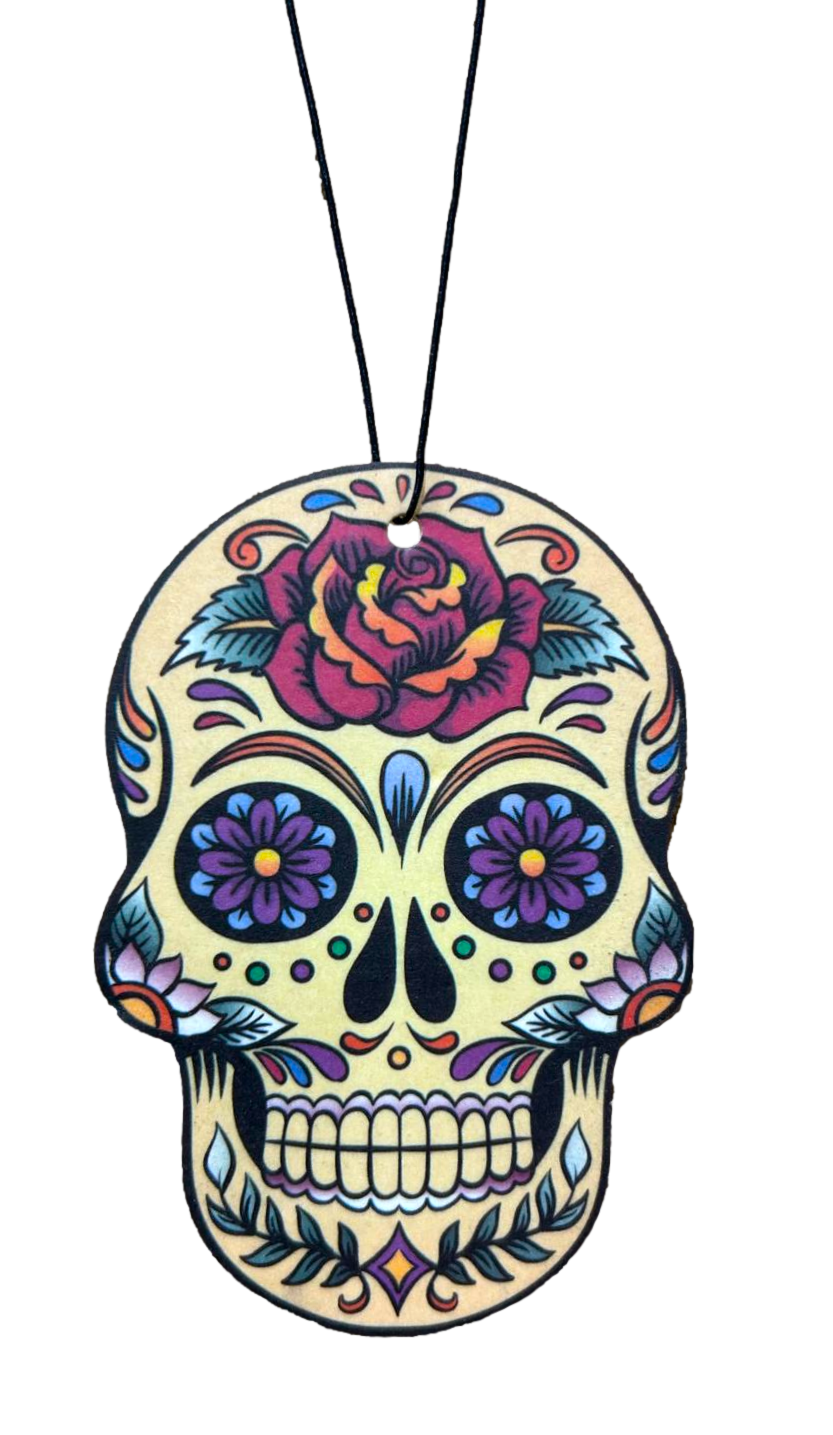 Colorful skull-shaped air freshener with floral designs on a white background