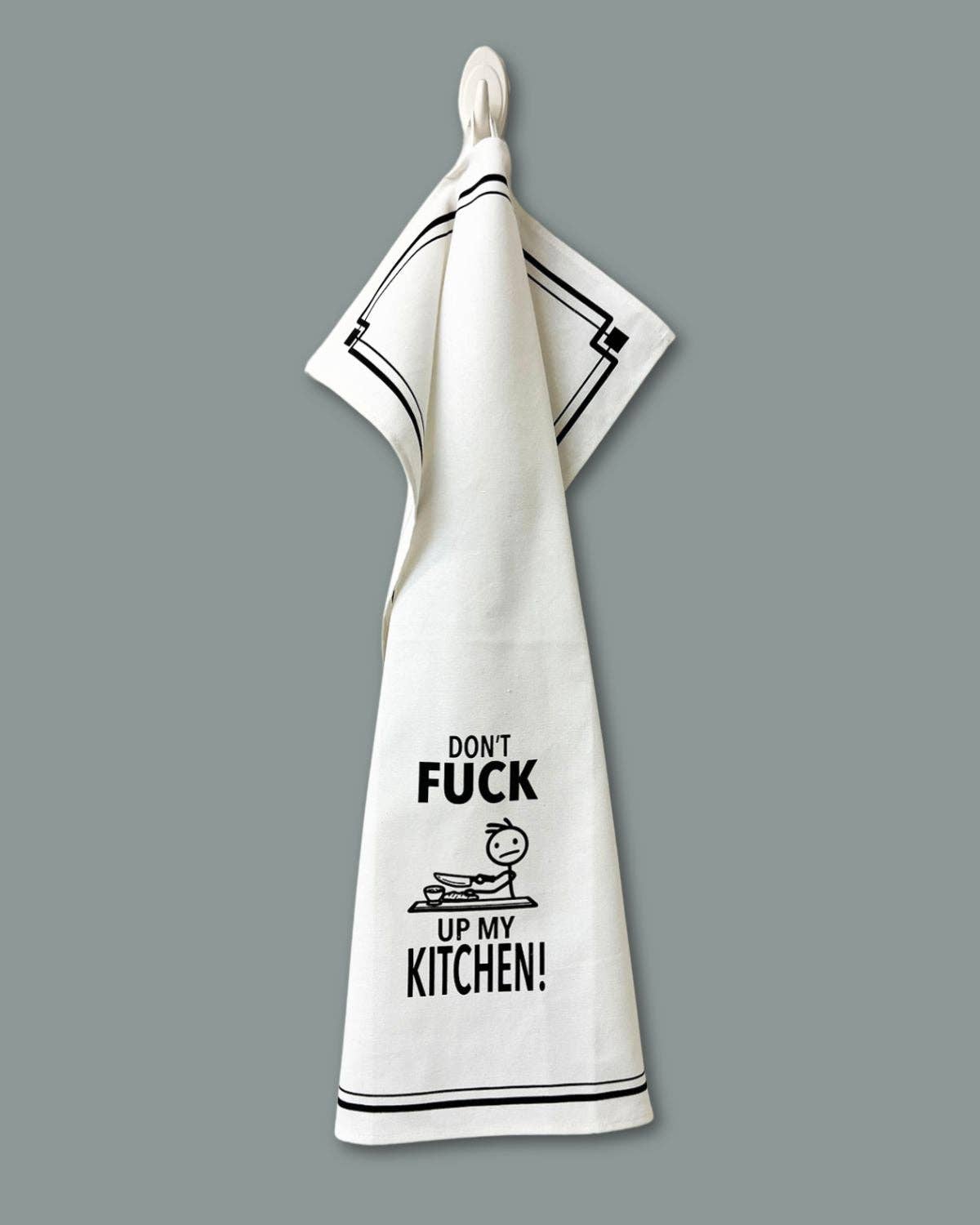 White towel with black text and graphic design on a gray background