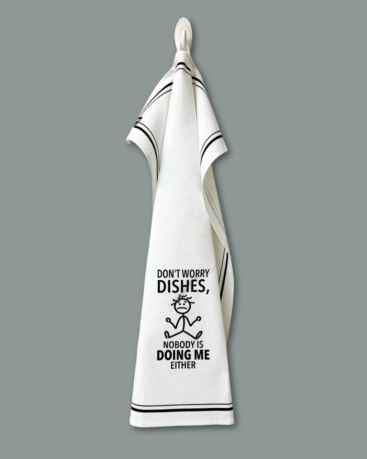 White towel with black text and graphic on a gray background