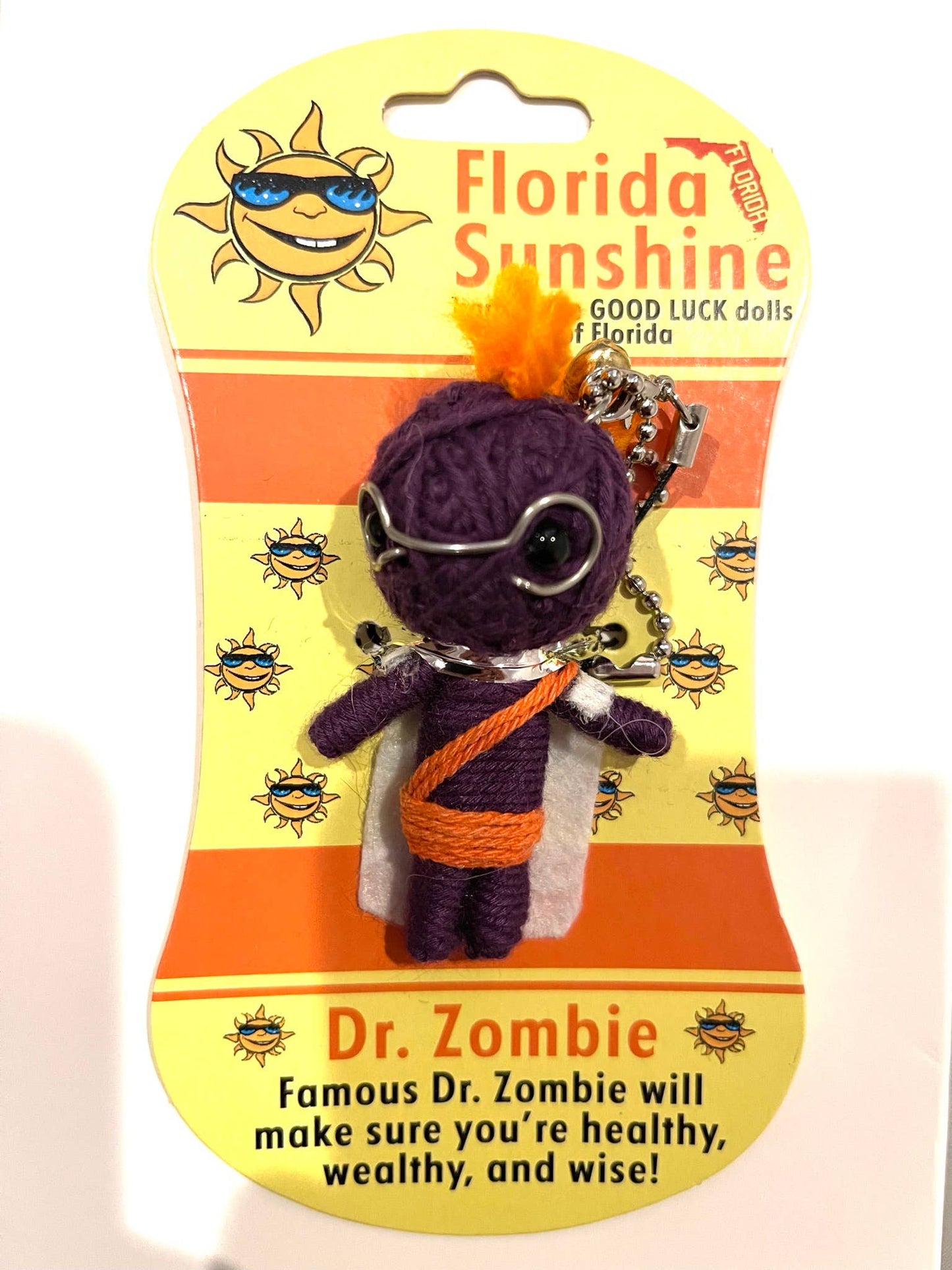 Good luck doll labeled 'Dr. Zombie' on a Florida Sunshine packaging with a yellow and orange design.
