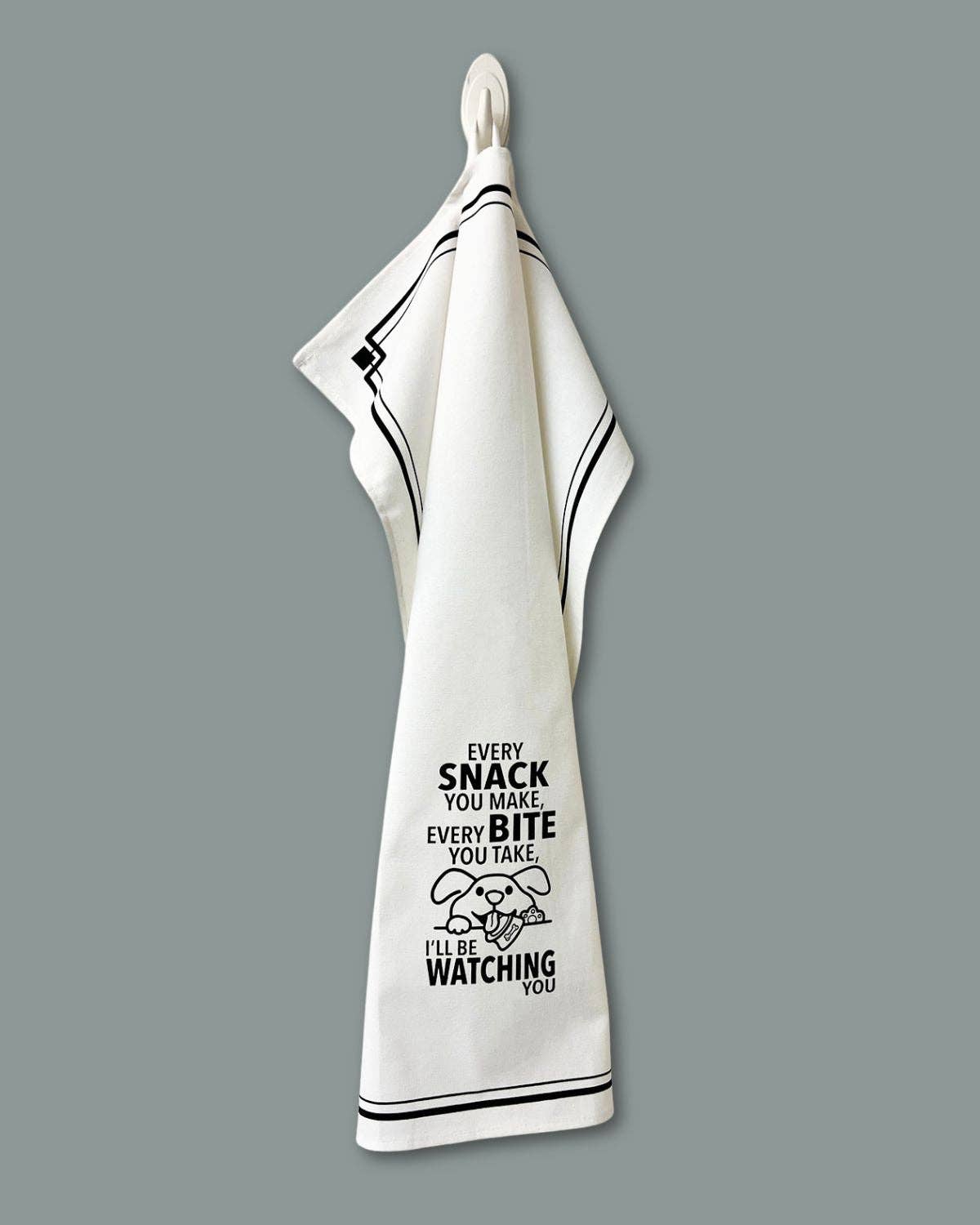 White towel with black text and graphic on a gray background