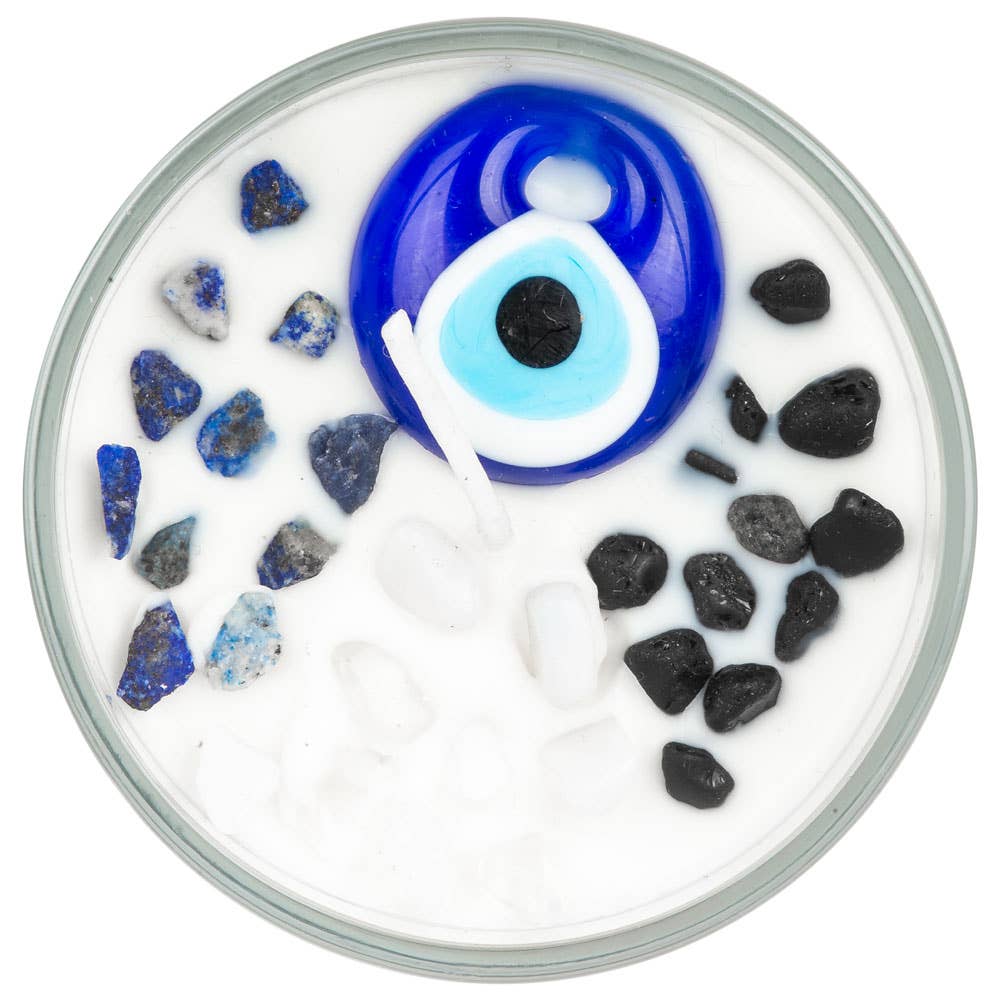 Decorative dish with a blue eye design and black and blue stones on a white background