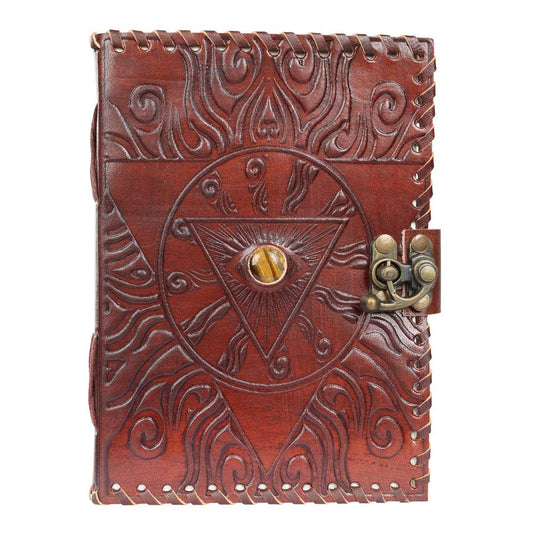 Brown leather journal with embossed design and lock on a white background
