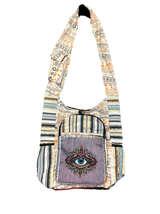 Patterned shoulder bag with an eye design on a white background