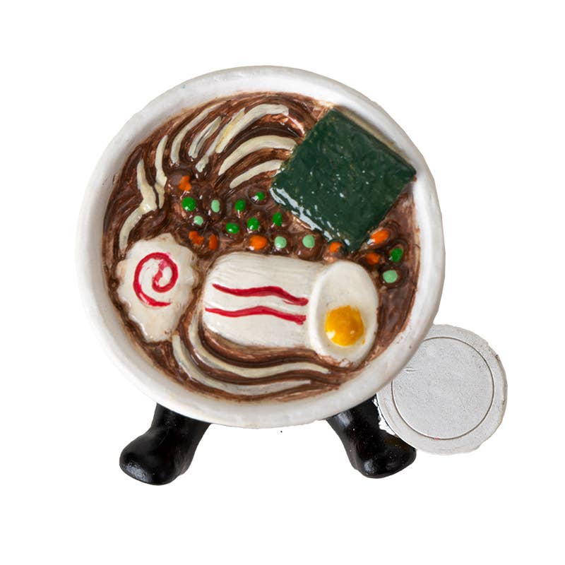 Miniature ceramic dish with food art on a white background