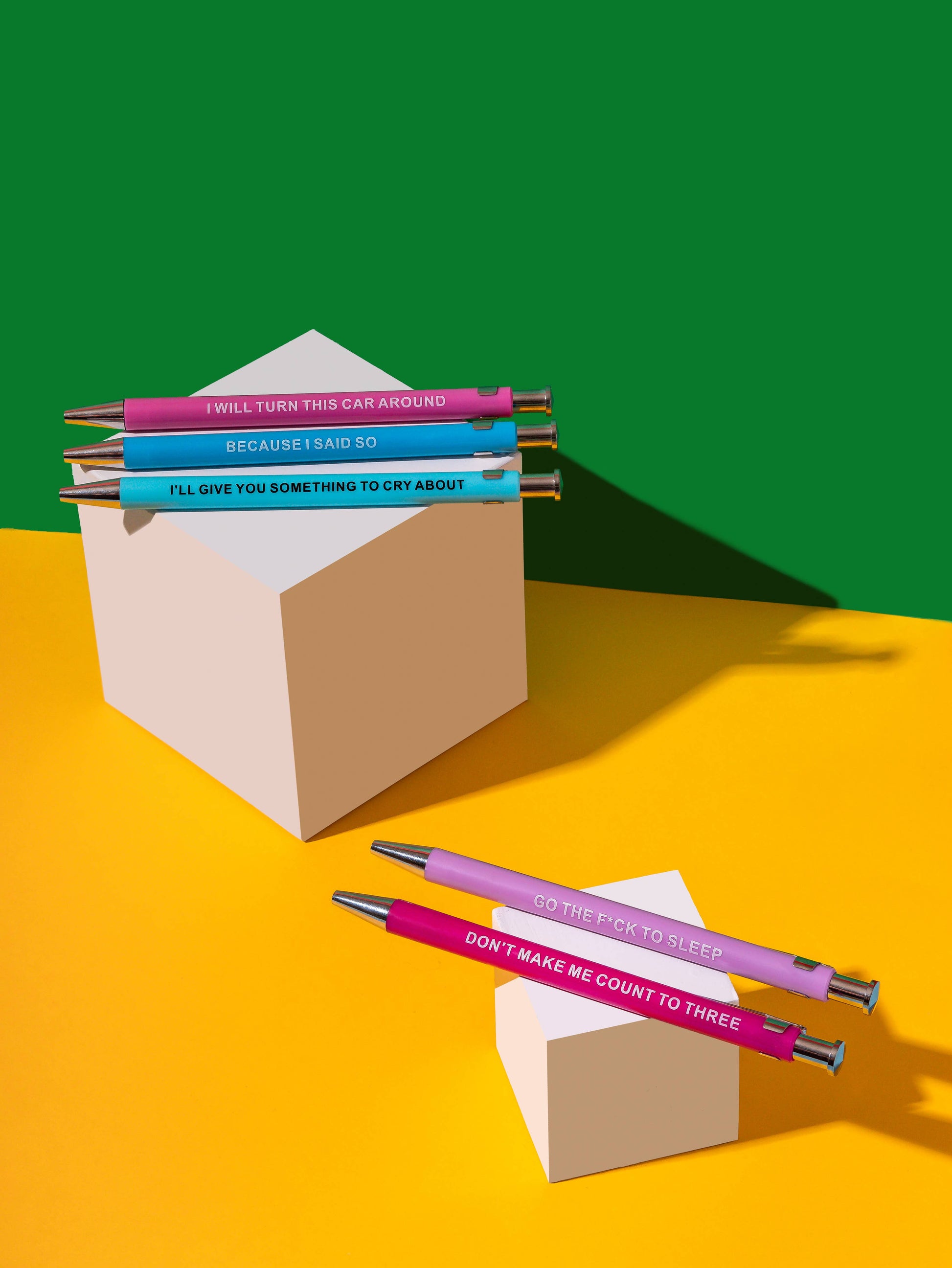 Colorful pens with humorous text on a yellow and green background