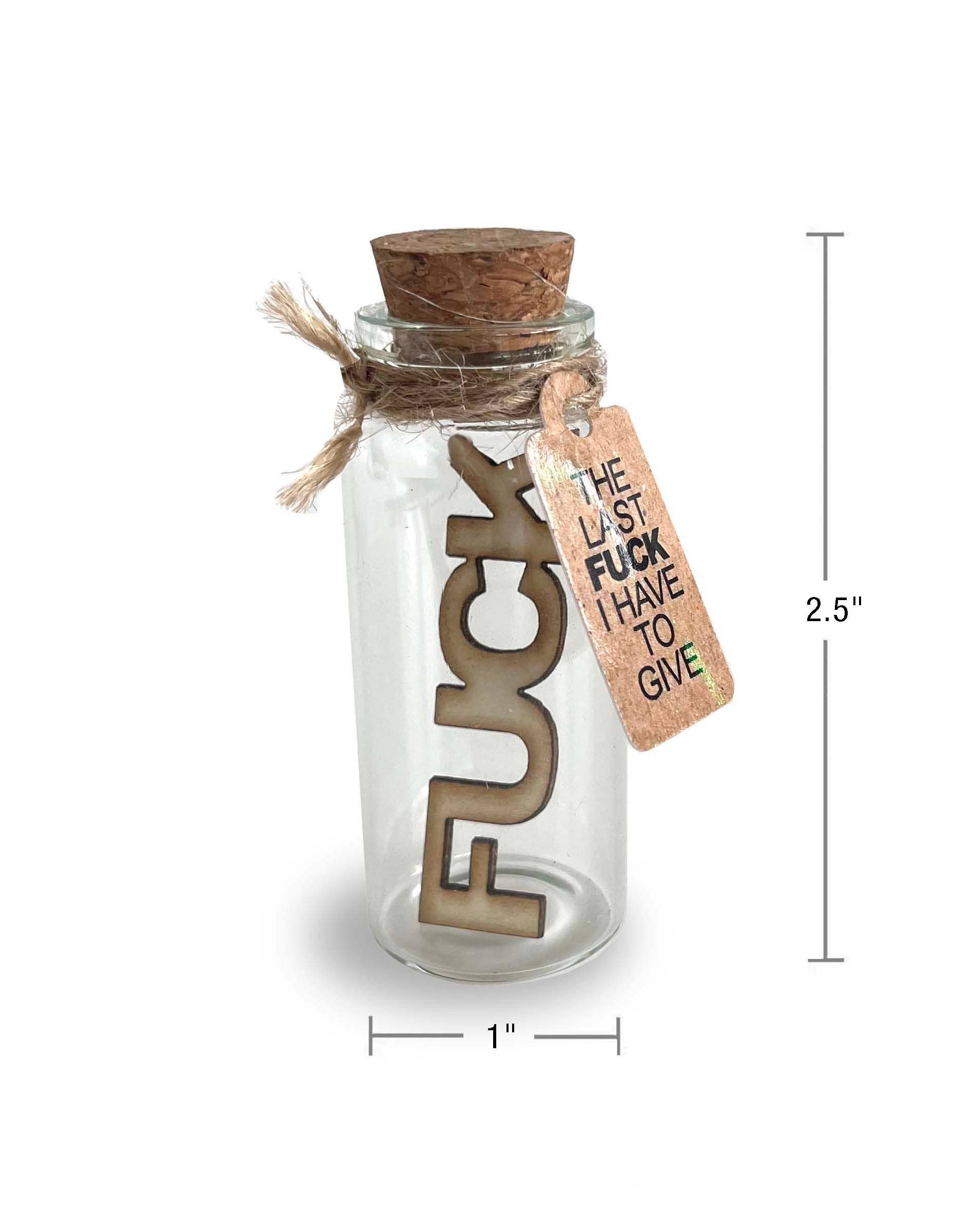 Glass bottle with cork lid containing a wooden letter 'F' and a tag, with dimensions indicated.