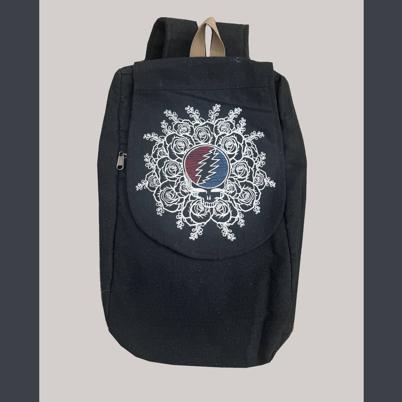 Black backpack with a decorative design on a gray background