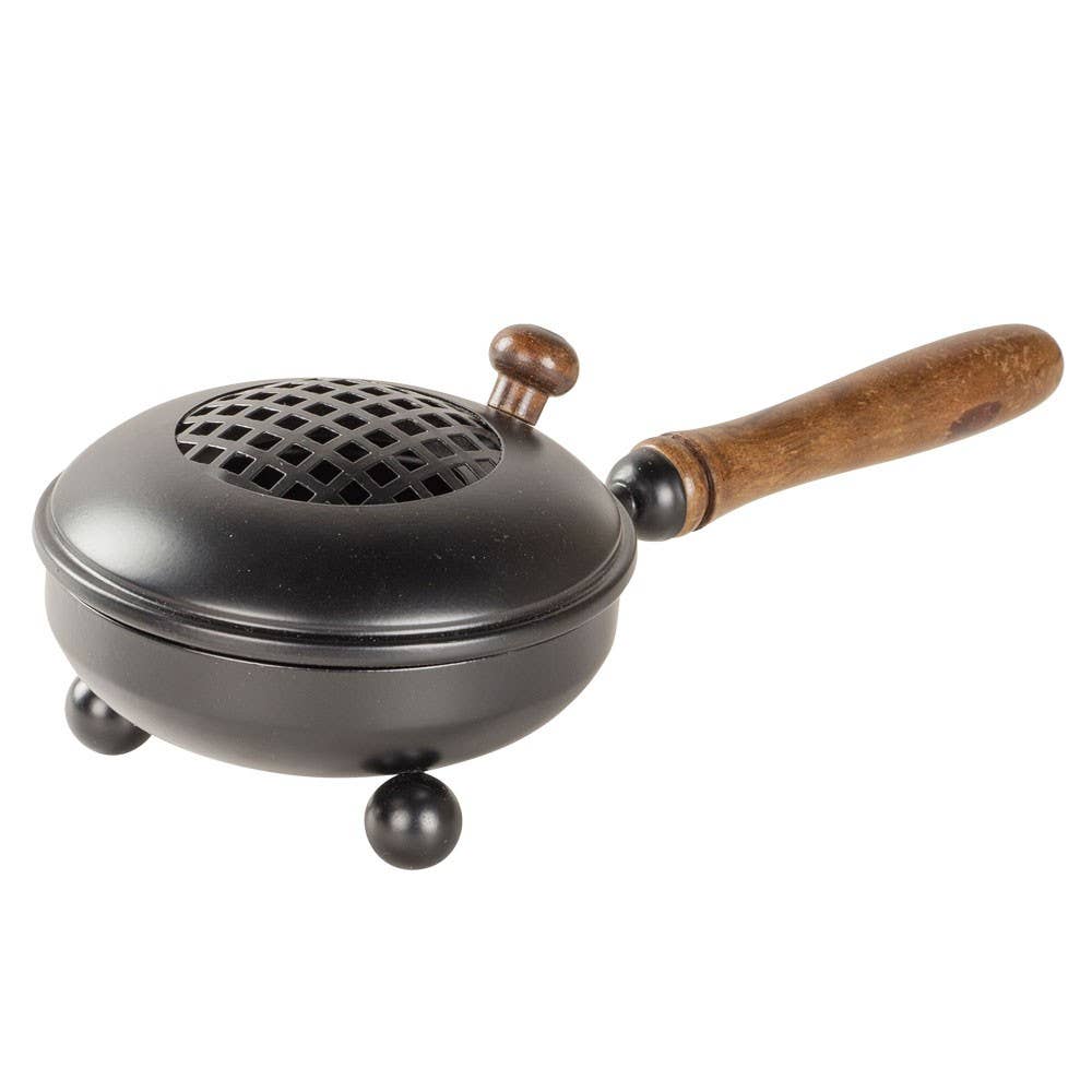 Black metal device with a wooden handle on a white background