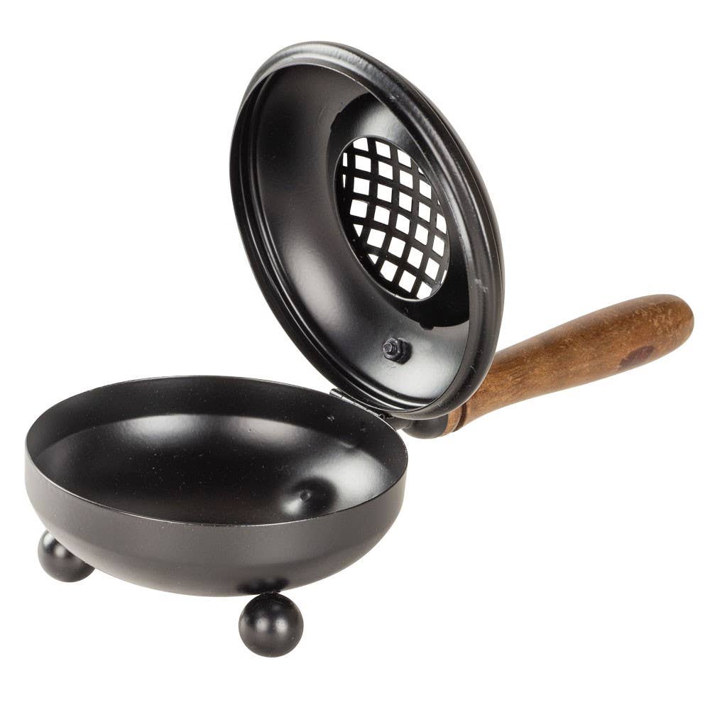 Black metal strainer with wooden handle on a white background