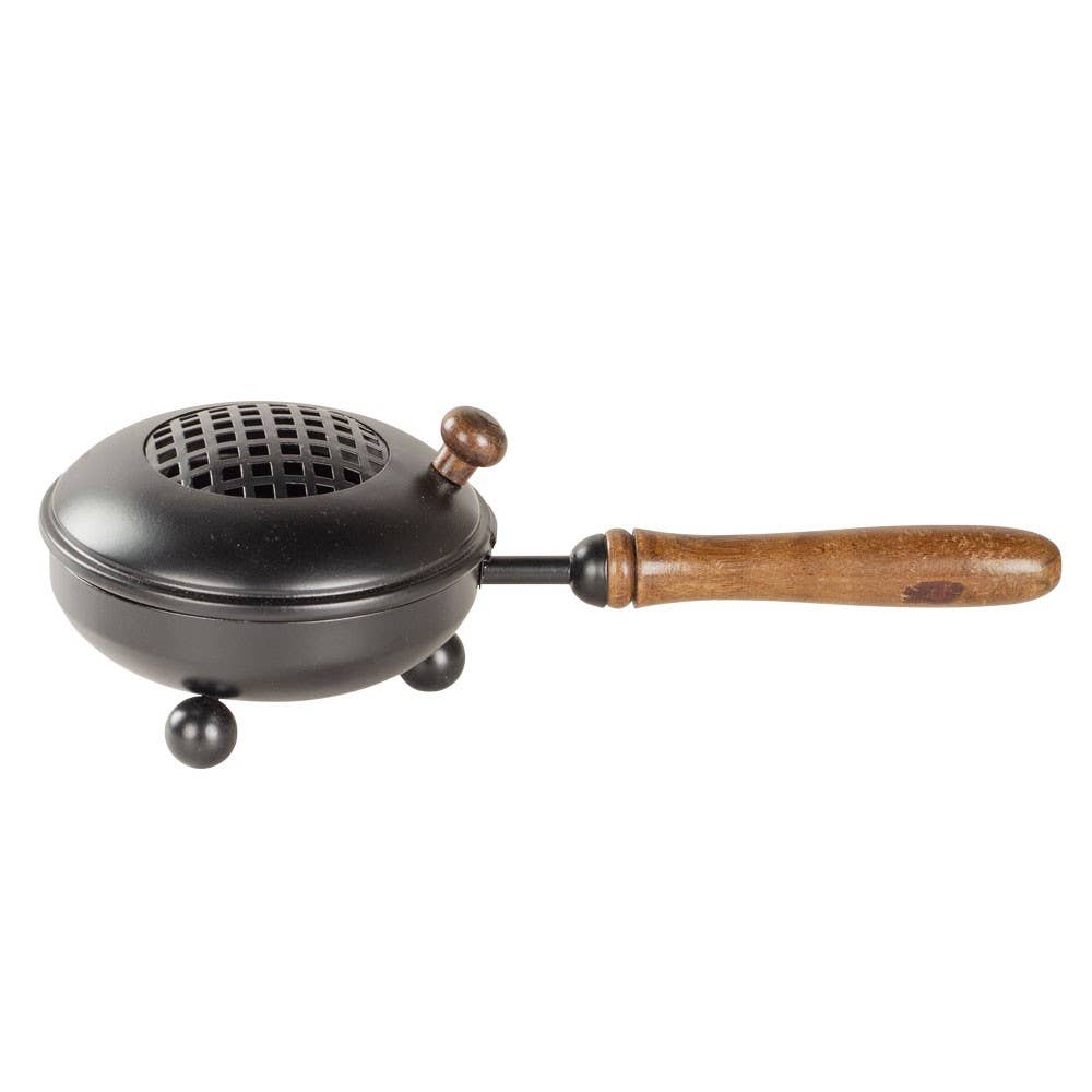 Black metal device with a wooden handle on a white background