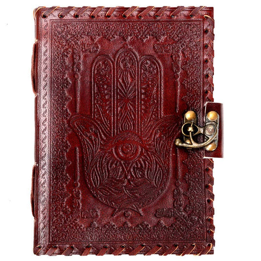 Decorative leather notebook with embossed design and lock on a white background