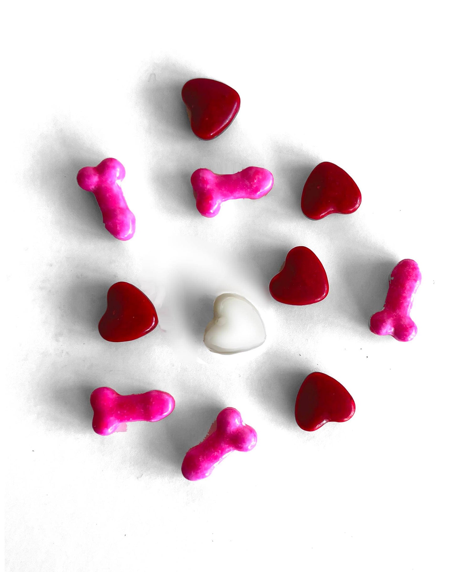 Colorful heart and bone-shaped candies on a white background