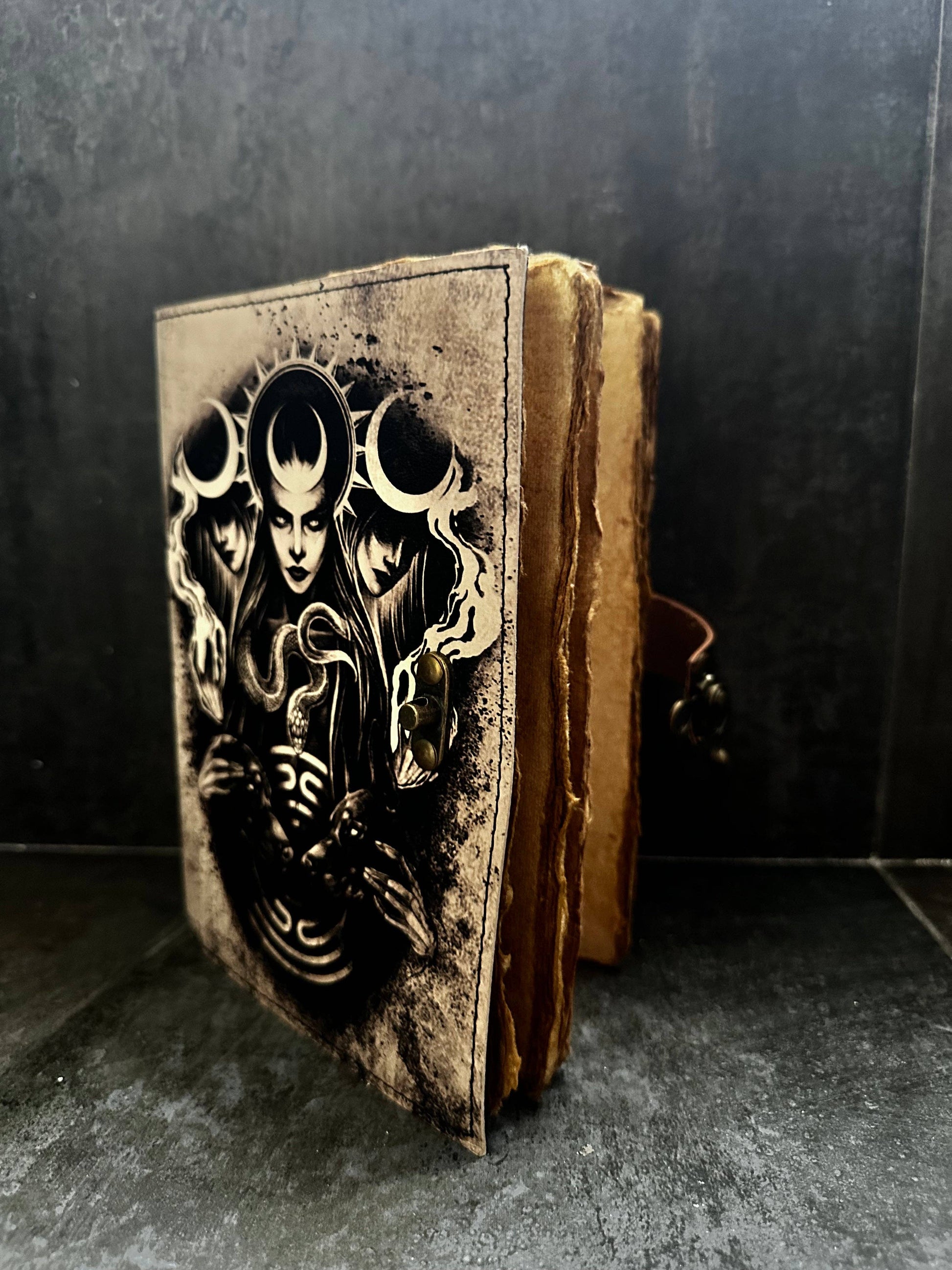 Decorative book with a face design on a dark background