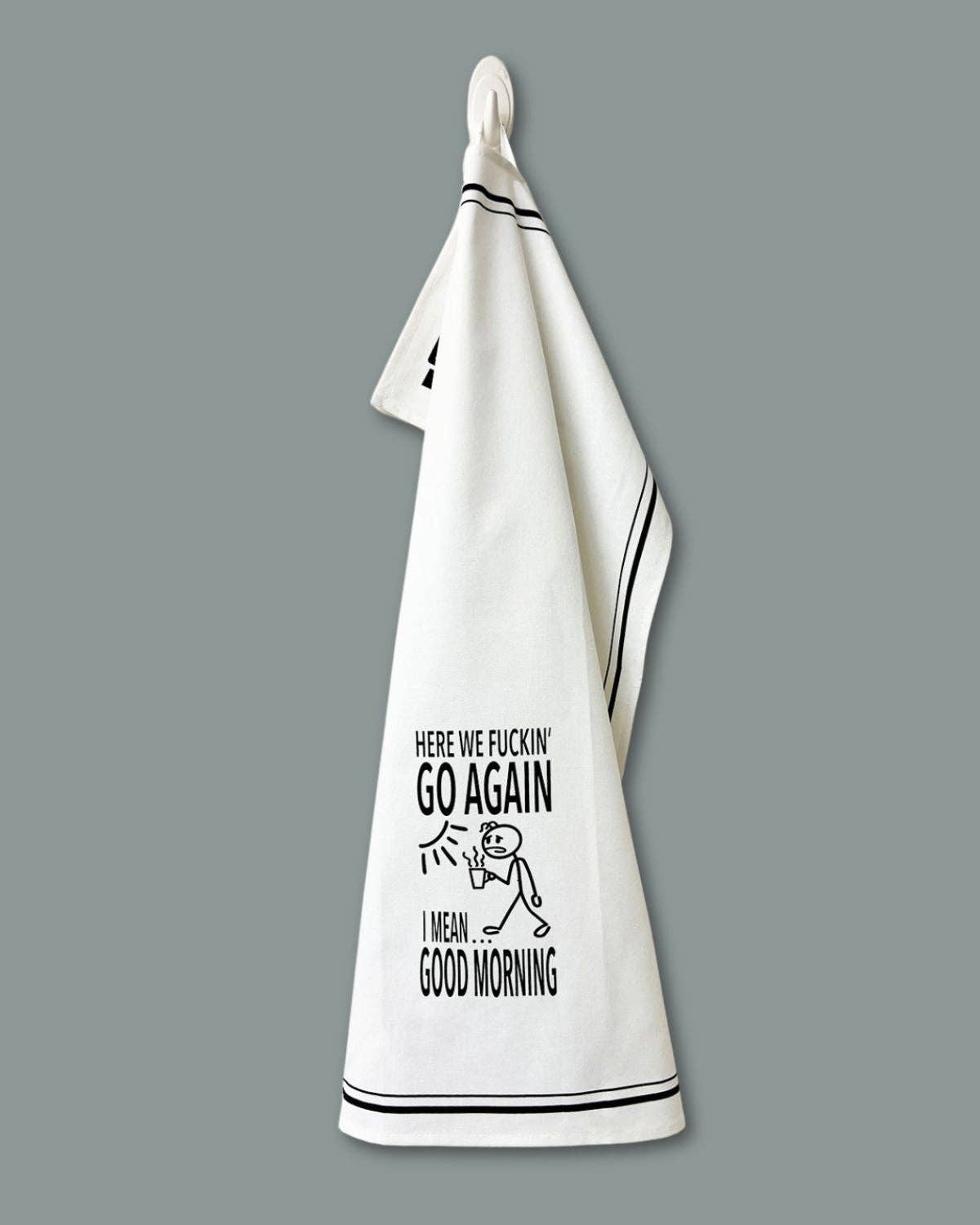 White towel with black text and graphic on a gray background