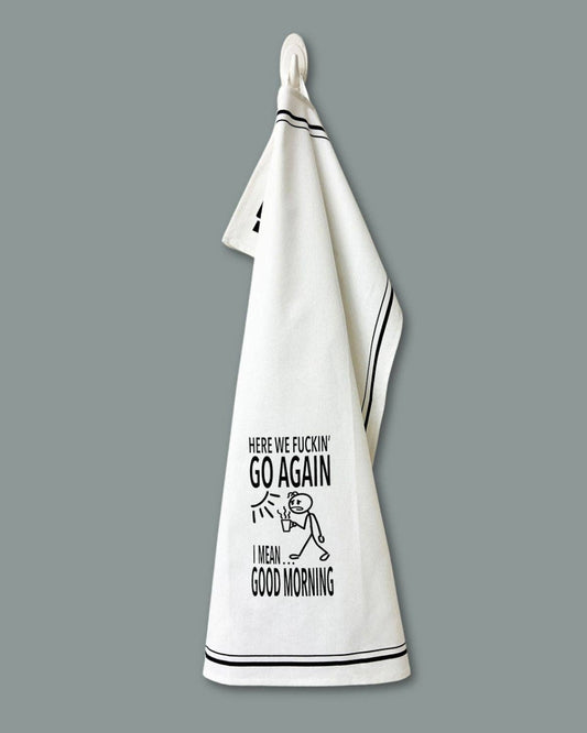 White towel with black text and graphic on a gray background