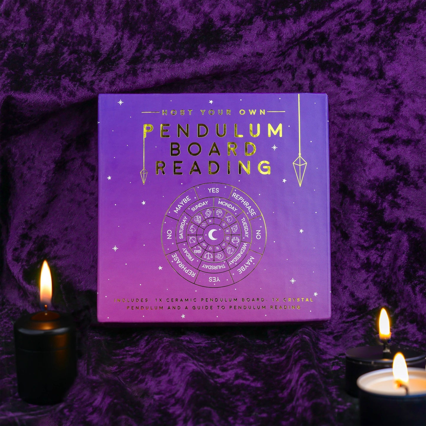 Pendulum board reading kit packaging on a purple textured background with candles.